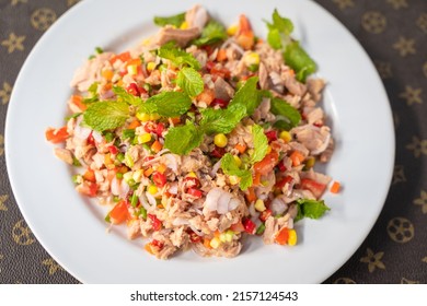 Spicy Tuna Salad With Chili, Shallots, Corn, Mint Leaves, Carrot, Lime And Tomatoes Cuisine In Plate Delicious Favorite Thai Food On Table. Top View Or Flat Lay Concept.