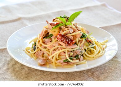 Spicy Tuna Spaghetti With Red Dried Chillies And Sweet Basil Leaves On White Dish.