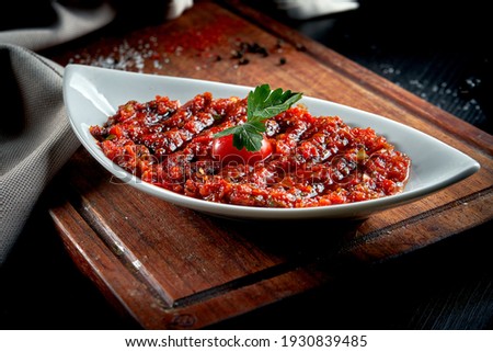 A spicy Turkish appetizer ezme made with tomatoes, bell pepper, parsley, mint, olive oil and hot chili. A kind of adjika Stok fotoğraf © 