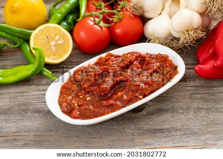 A spicy Turkish appetizer ezme made with tomatoes, bell pepper, parsley, mint, olive oil and hot chili. A kind of adjika Stok fotoğraf © 