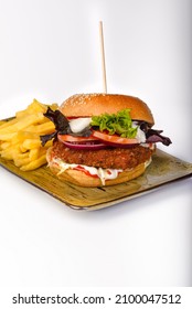 Spicy Veg Bean Burger In A Toasted Burger Bun And Served With French Fries