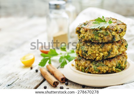 spicy vegan curry burgers with millet, chickpeas and herbs. the toning. selective focus