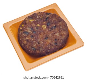 Spicy Vegetarian Black Bean Burger On An Orange Plate.