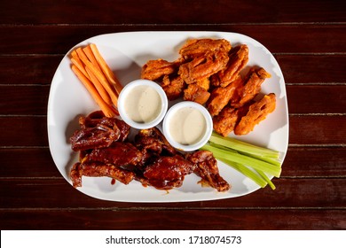 Spicy Wings And BBQ With Dressing And Vegetables