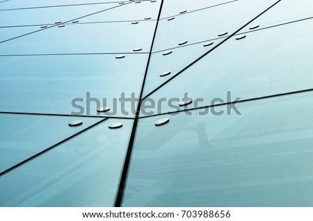 Spider facade fixing system. Elements of fastening of the facade. Facade detail. Chaotically located elements of the glass facade. Abstract Architecture Background