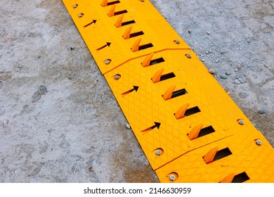 Spike barrier or strip on the road for control the traffic. yellow mechanical spike barrier.