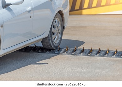 Spikes barrier are frequently used to enforce a directional flow in a single traffic lane. Car departing from the parking lot