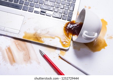 Spill coffee on a computer keyboard - Shutterstock ID 1252729444
