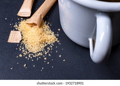 Spilled Cane Sugar From A Paper Bag. Sweetening Tea With Sugar. Dark Background.