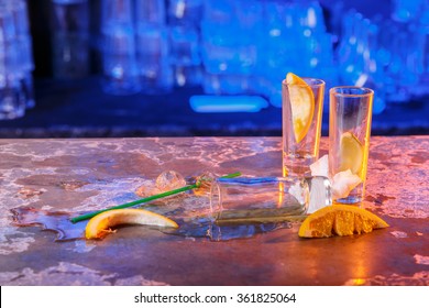 The Spilled Cocktails With Ice Cubes On Blue Color In The Bar