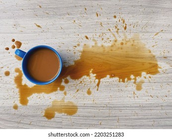 Spilled coffee, top view cup of spilled coffee  on the wooden floor.  - Powered by Shutterstock
