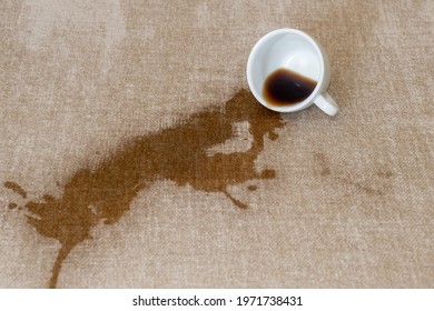 Spilled Cup Of Coffee On The Sofa With Dirty Stain.