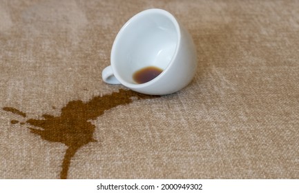 Spilled Cup Of Coffee On The Sofa With Dirty Stain.