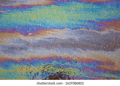 Spilled Fuel. A Beautiful Multi-colored Spot. Gasoline Stains On The Surface. Bright Acid Colors. Abstract Texture. All Colors In One Fuel Spot. Gasoline Crisis.