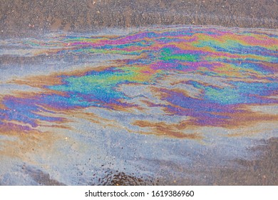 Spilled Fuel. A Beautiful Multi-colored Spot. Gasoline Stains On The Surface. Bright Acid Colors. Abstract Texture. All Colors In One Fuel Spot. Gasoline Crisis.