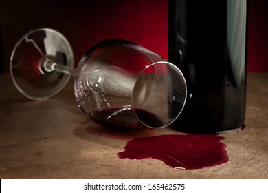 Spilled glass of wine on table after party