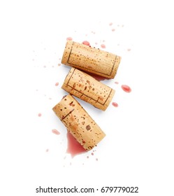 Spilled red wine and corks isolated on white background - Shutterstock ID 679779022