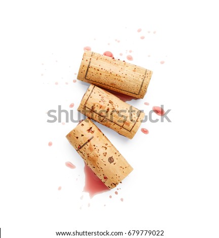 Spilled red wine and corks isolated on white background