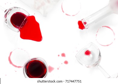 Spilled Red Wine, Glasses And A Bottle On The White Table