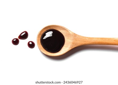 Spilled Soy Souse, Teriyaki Sauce, Oyster Sauce or Balsamic Vinegar Puddles on wooden spoon isolated on white background, top view.
