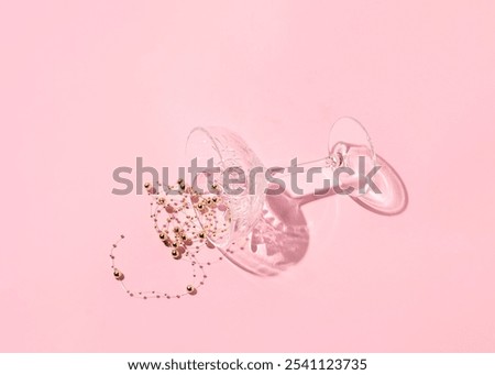 Spilled sparkling drink on a candy pink background. Champagne party.