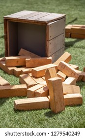 Spilled Wooden Blocks For Stacking Jenga Game, On An Artificial Grass Lawn, In A Gaming Background