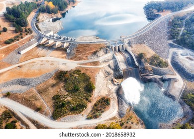 Spillway of Jindabyne lake power hydro dam on Snowy River in Snowy Mountains of Australia - aerial top down view.