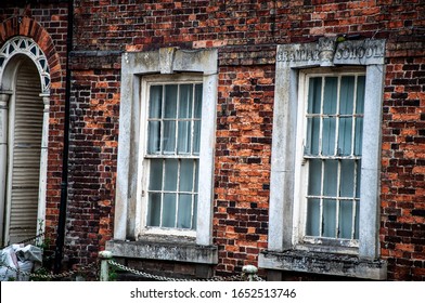 SPILSBY, LINCOLNSHIRE / UK - Circa JUNE 2019: Closeup Of Windows Of Brick Built Grade II Listed King Edward VI Grammar School In Bad State Of Repair