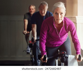 Spin class, gym or senior woman on bike in workout or training for cycling progress, health or wellness. Group, challenge or confident elderly person on bicycle machine for fitness or cardio exercise - Powered by Shutterstock