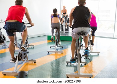 Spin Class Working Out With Motivational Instructor At The Gym