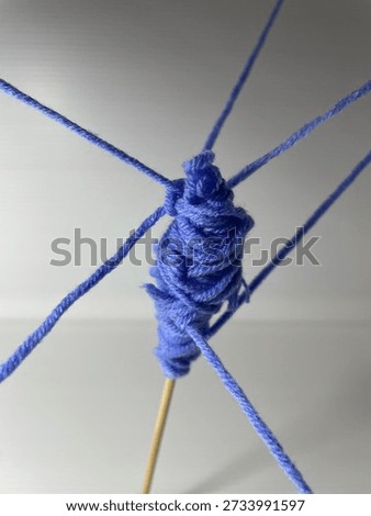Spin control. A thread from different directions merging on a stick. An analogy from public relations (PR).