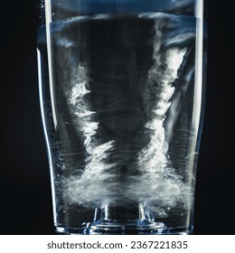 Spin water in glass, Abstract black background, water splash with bubbles. - Powered by Shutterstock