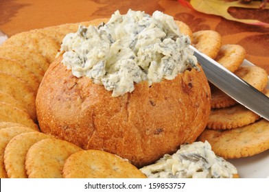 Spinach, Artichoke And Parmesan Dip In A Bread Bowl With Crackers