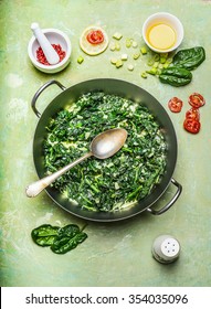Spinach In Cream Sauce In Cooking Pot With Spoon, Top View