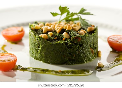 Spinach Garnish with Pesto Sauce and Tomato. Vegan Food. Healthy Eating