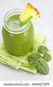 Spinach Green Smoothie Topped With A Pineapple Slice