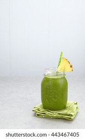 Spinach Green Smoothie Topped With A Pineapple Slice