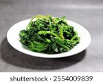 Spinach greens blanched in boiling water. Spinach vegetables seasoned with salt and sesame oil.
