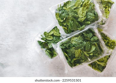 Spinach and Japanese mizuna packaged in clear plastic containers on rustic background. Top view, blank space
 - Shutterstock ID 2259531501