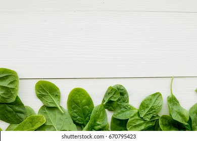 Spinach Leaves On White Wooden Table Top View