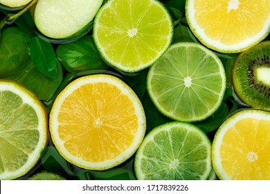 Spinach Leaves And Slices Of Lemon, Lime, Apple And Kiwi. Vitamin C In Fruits, Fruit Citrus Background.