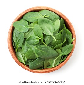 Spinach leaves in a wooden plate on a white. Top view. - Shutterstock ID 1929965306