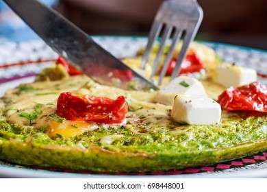 Spinach Omelette With Tomatoes And Cheese On Top