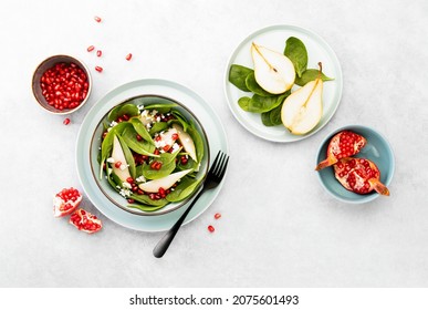 Spinach And Pear Salad With Goat Cheese And Pomegranate Seeds, Top Down View