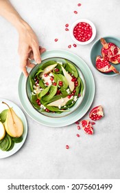 Spinach And Pear Salad With Goat Cheese And Pomegranate Seeds, Top Down View