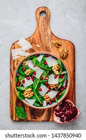 Spinach Salad Bowl With Pomegranate Seeds, Walnuts And Cheese Slices. Top View