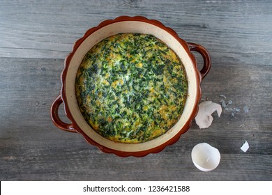 Spinach Souffle In Rustic Round Dish With Egg Shells Flat Lay