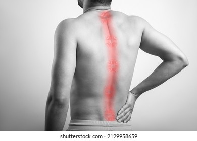 Spine Inflammation, Backache, Spinal Cord Injury, Human Spine. Black And White Male Suffering From Spinal Cord Pain Highlighted In Red Glow.