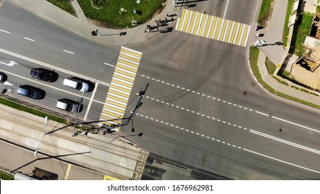Spinning around road junction with cars, aerial footage of road cross in town