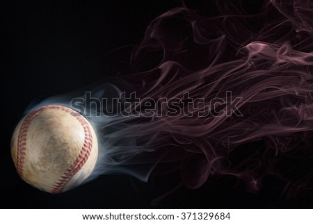 Spinning baseball, leaving a trail of smoke.